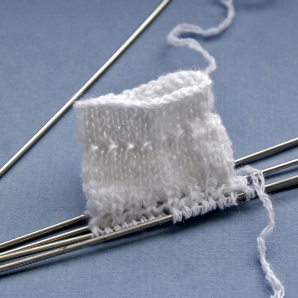 Chaussette Pagolenok avec des aiguilles à tricoter à motifs
